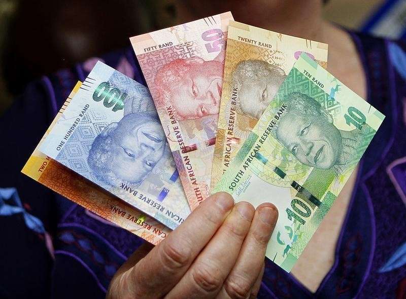 The hand of South African Reserve Bank Governor Gill Marcus is seen holding South Africa's new rand banknotes in Pretoria