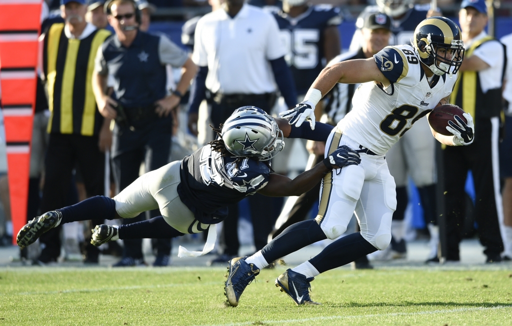 Aug 13 2016 Los Angeles CA USA Los Angeles Rams tight end Tyler Higbee avoids a tackle by Dallas Cowboys free safety J.J. Wilcox during the second quarter at Los Angeles Memorial Coliseum. Mandatory Credit Kelvin Kuo-USA TODAY Sports