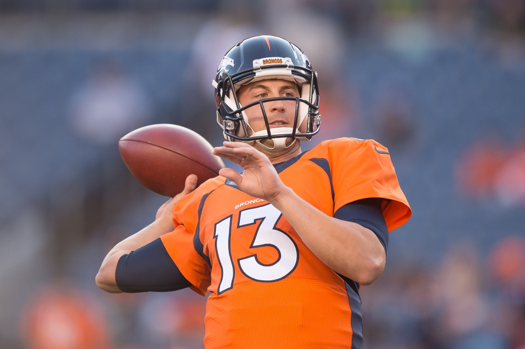 Quarterback Trevor Siemian of the Denver Broncos throws as he warms up before a preseason NFL game at Sports Authority Field at Mile High