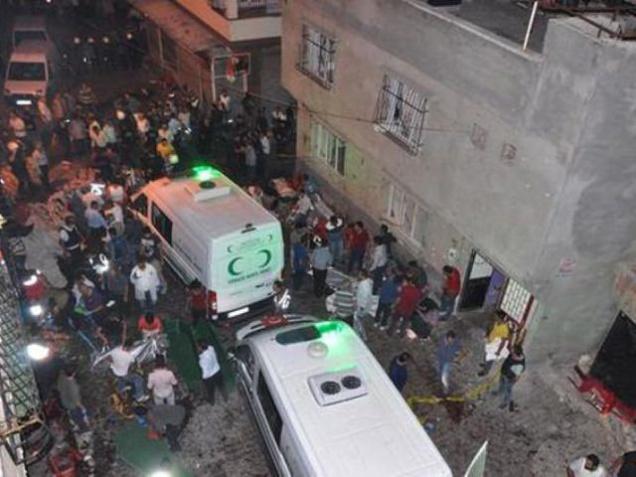 People carry dead bodies into ambulances after an explosion in Gaziantep southeastern Turkey early on Sunday. A bomb attack targeting an outdoor wedding party there killed several at least 27 people and wounded dozens. Deputy Prime Minister Mehmet Simse