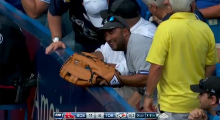 A Blue Jays fan catches a foul ball with ease thanks to a giant glove he brought with him to the game