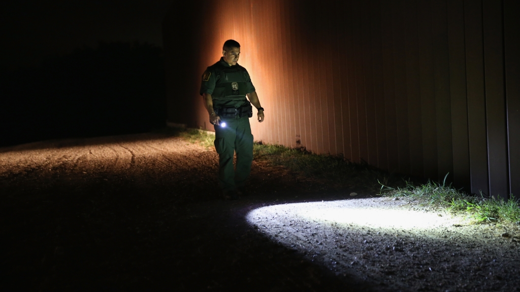 A Border Patrol agent checks for footprints near the U.S. border with Mexico on April 13 in Weslaco Texas