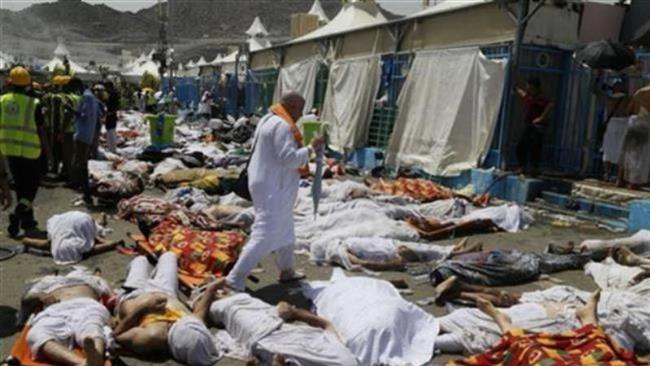 A Muslim pilgrim walks through dead bodies at the site of a crush in Mina near Mecca Saudi Arabia