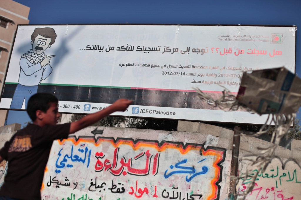 A Palestinian next to an elections billboard in Gaza