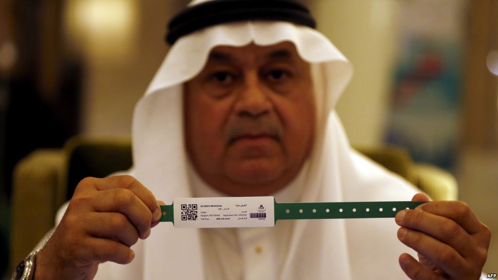 A Saudi official displays an electronic identification bracelet that Saudi authorities are giving to pilgrims ahead of the hajj