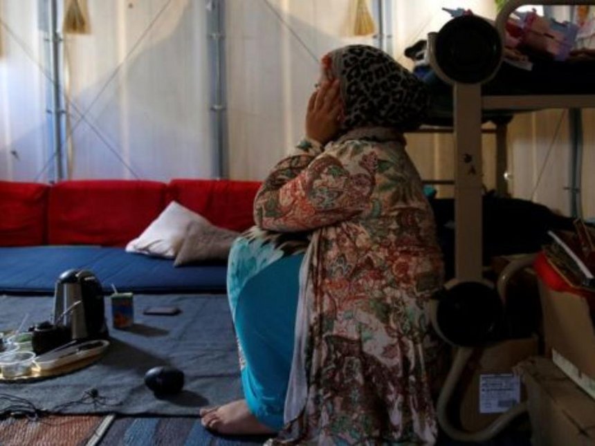 A Syrian refugee sits inside her family's tent on the island of Chios in Greece./COURTESY