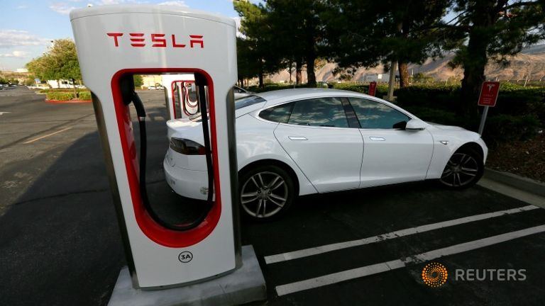 A Tesla Model S charges at a Tesla Supercharger station in Cabazon California