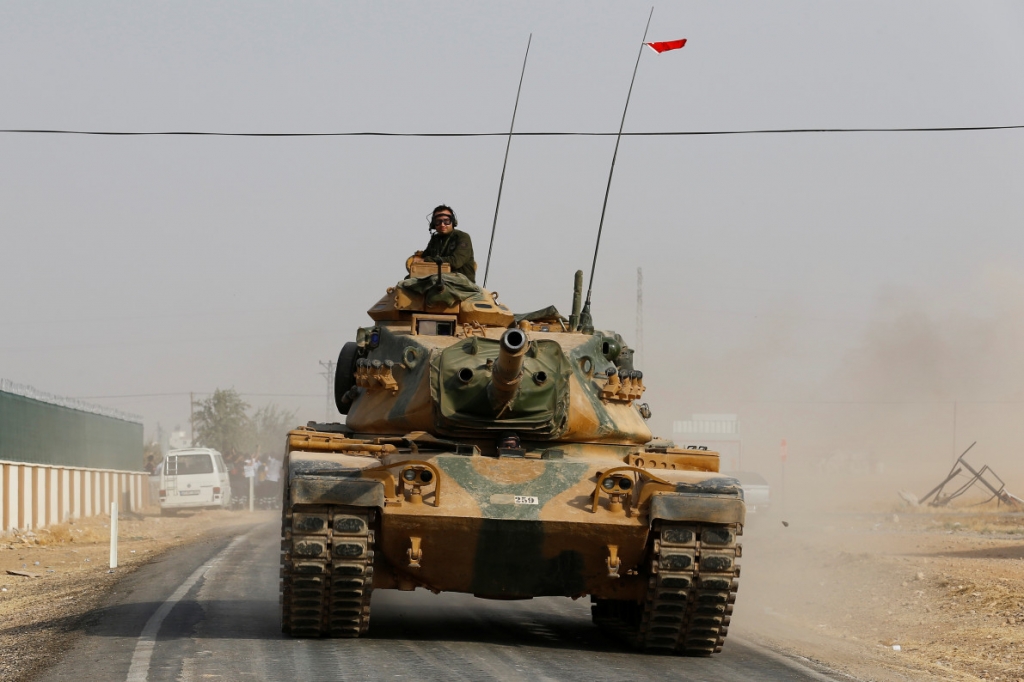 A Turkish army tank drives towards the Turkey Syria border August 25. — REUTERS