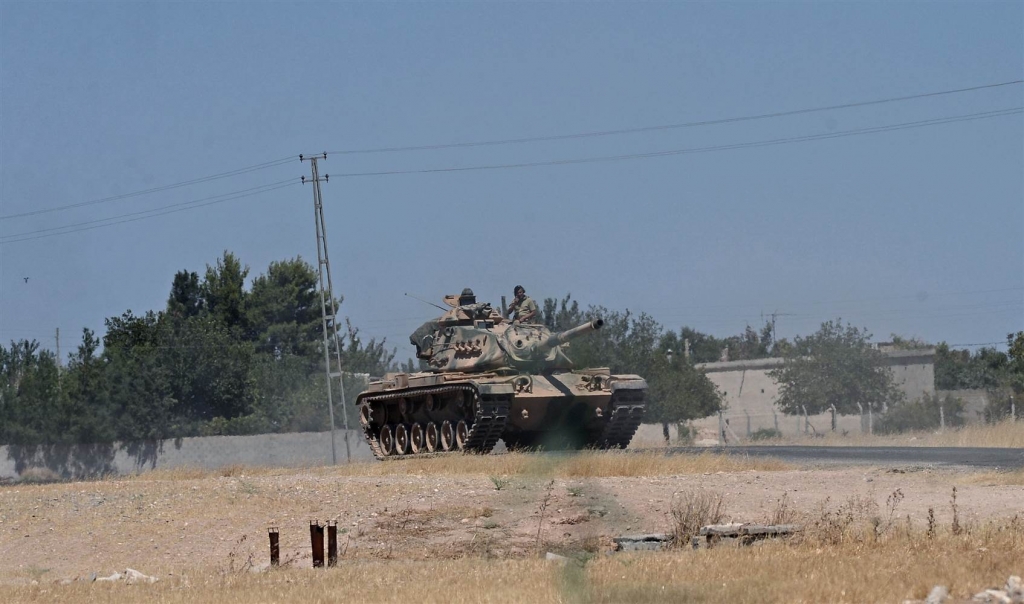 A Turkish tank heads to the Syrian border