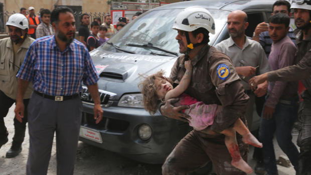 A civil defence member carries an injured girl after an airstrike in the rebel-controlled city of Idlib Syria. REUTERS  Ammar Abdullah