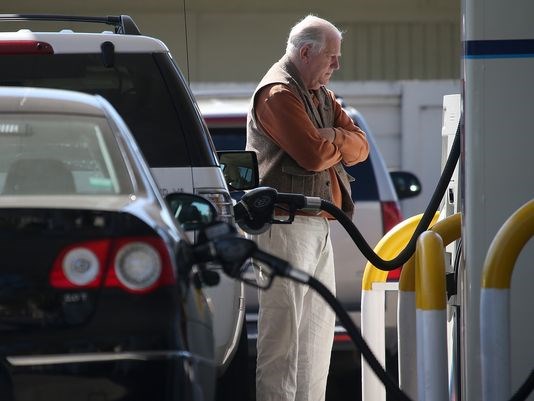 A customer pumps gasoline into his car at an Arco gas station