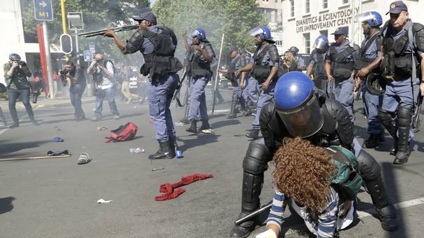 A female student is arrested as police fired stun grenades and rubber bullets in an attempt to disperse them during a protest in Johannesburg