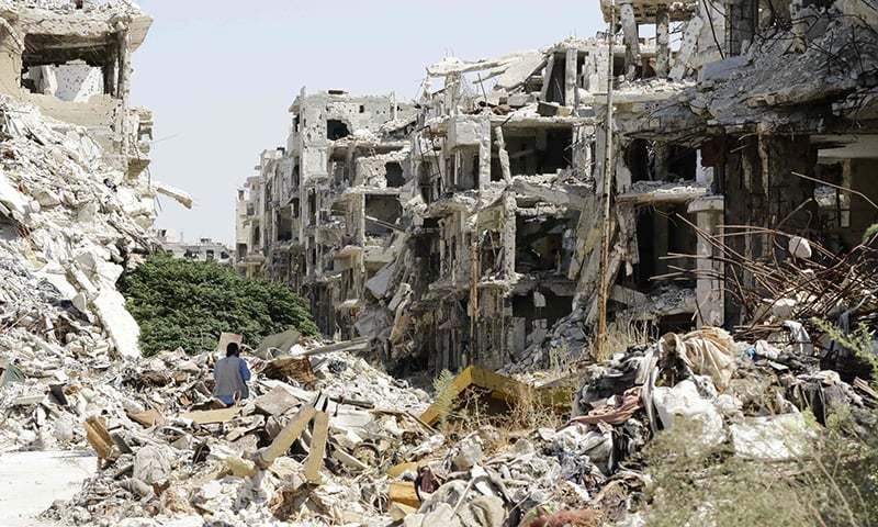 A general view shows destroyed buildings in the government-held Jouret al Shiah neighbourhood of the central Syrian city of Homs. — AFP