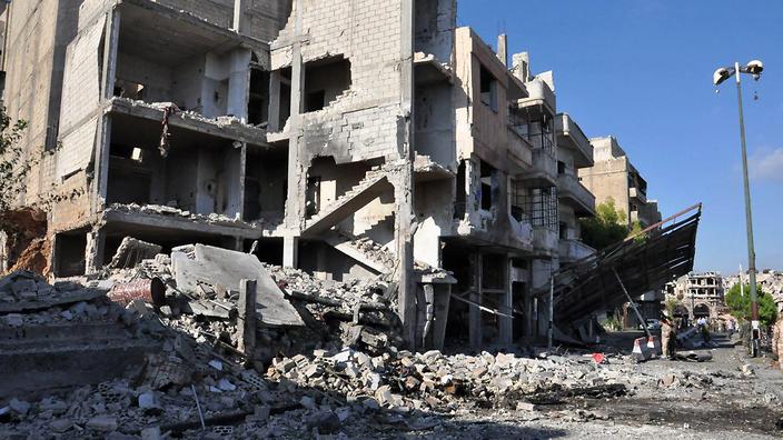 Syria's Arab News Agency shows damaged buildings at Bab Tadmour district in the old city of Homs Syria