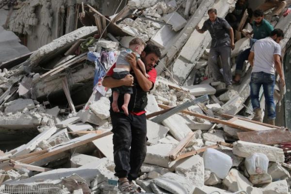 A man carries an injured child after airstrikes on the rebel held al Qaterji neighbourhood of Aleppo. REUTERS  Abdalrhman Ismail