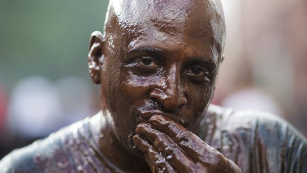 A man covered in chocolate during the Notting Hill Carnival in London England