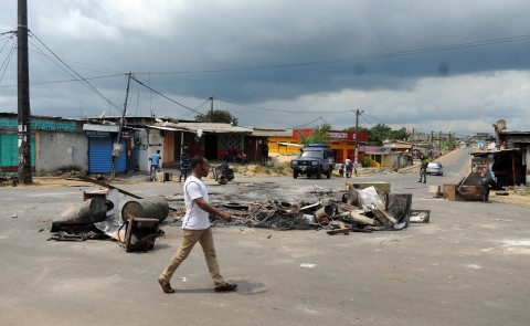 A man walk past a barricade after an election protest in Libreville Gabon on Thursday