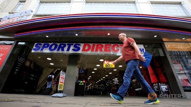 A man walks past a Sports Direct store on Oxford Street in London Britain