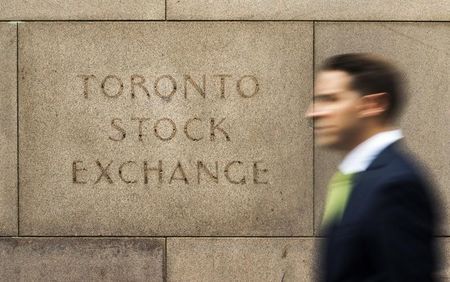 A man walks past an old Toronto Stock Exchange sign in Toronto