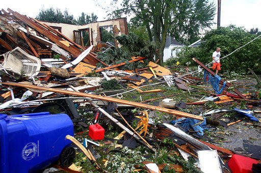 A man walks through debris after a tornado in Kokomo Ind. Wednesday Aug. 24 2016