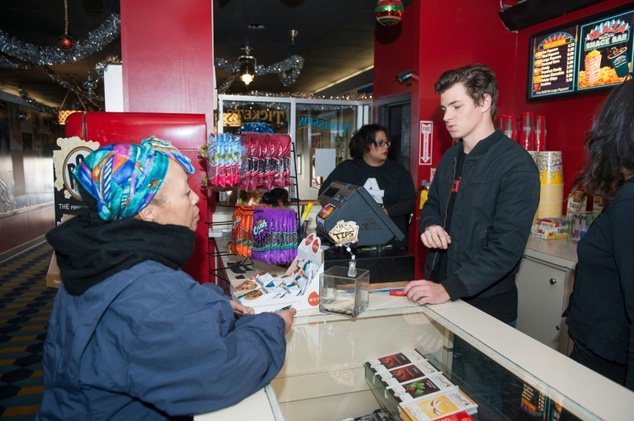 A movie goer purchases a ticket in Atlanta Georgia