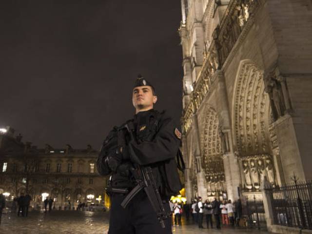 A police man on guard outside Notre Dame Cathedral in the centre of Paris