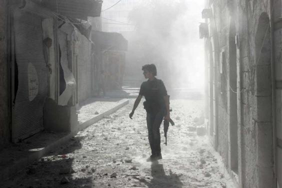 A rebel fighter on the streets of Aleppo in April