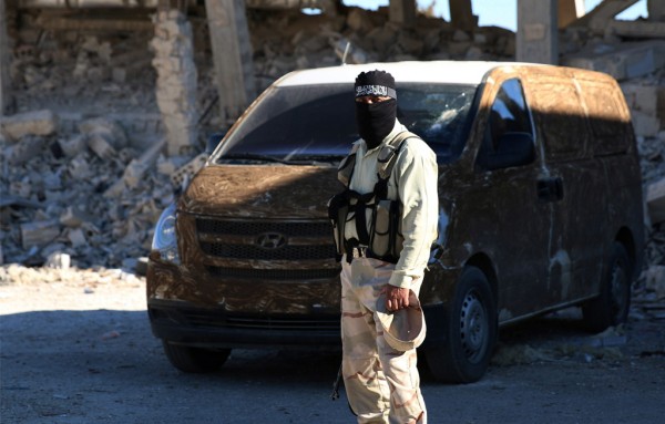 A rebel fighter stands near a vehicle in Quneitra countryside Syria