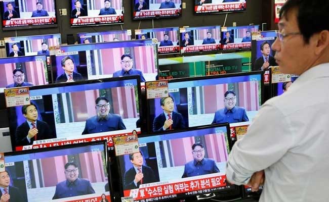 A sales assistant watches a news report on North Korea's fifth nuclear test in Seoul