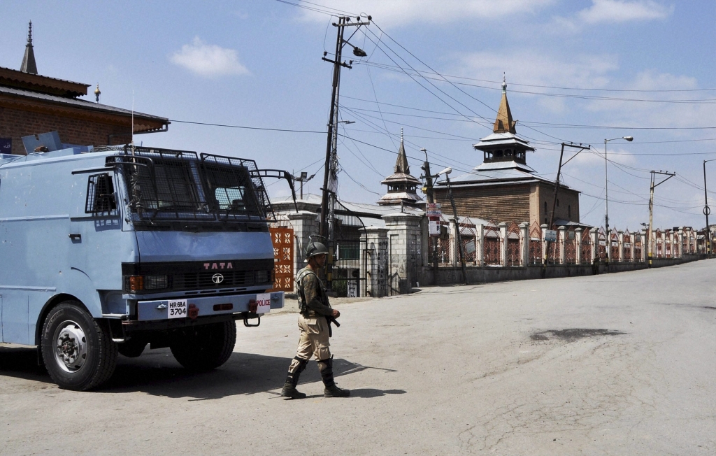 A security jawan stands guard on a deserted street near Jamia Masjid during the 66th day of restrictions and strike in Srinagar on Monday. Credit PTI