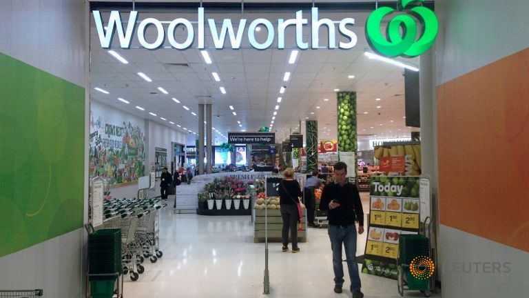 A shopper walks out of a Woolworths store in Sydney Australia