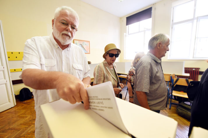 A voter casts his ballot at a polling station during voting in the general election in Zagreb | STR  AFP via Getty Images