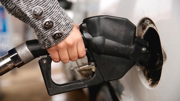 A woman pumps gas at a station in Falls Church Virginia