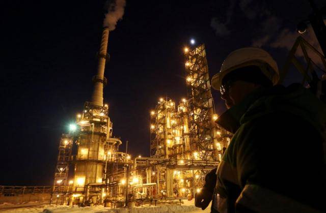 A worker looks on at the Bashneft Ufaneftekhim oil refinery outside Ufa