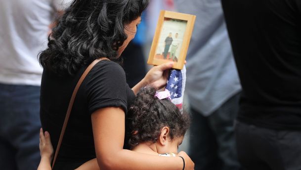 A young girl holds her mother during a commemoration ceremony for the victims of the September 11 NYC. AFP  Spencer Platt