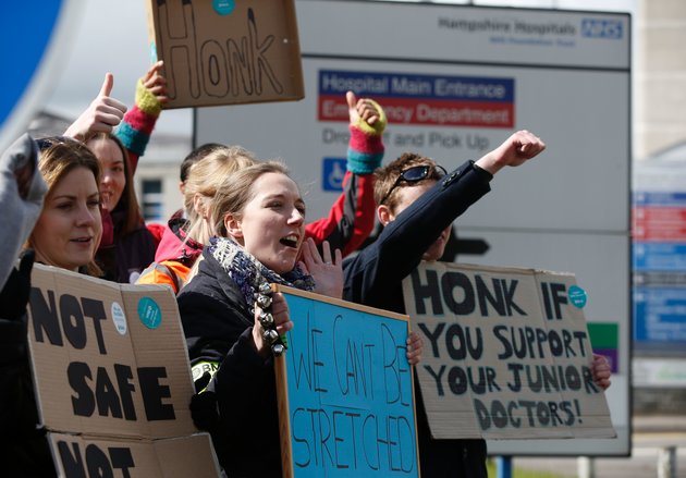 ADRIAN DENNIS via Getty Images
Demonstrators and Junior doctors hold placards as they protest outside the Basingstoke and North Hampshire Hospital