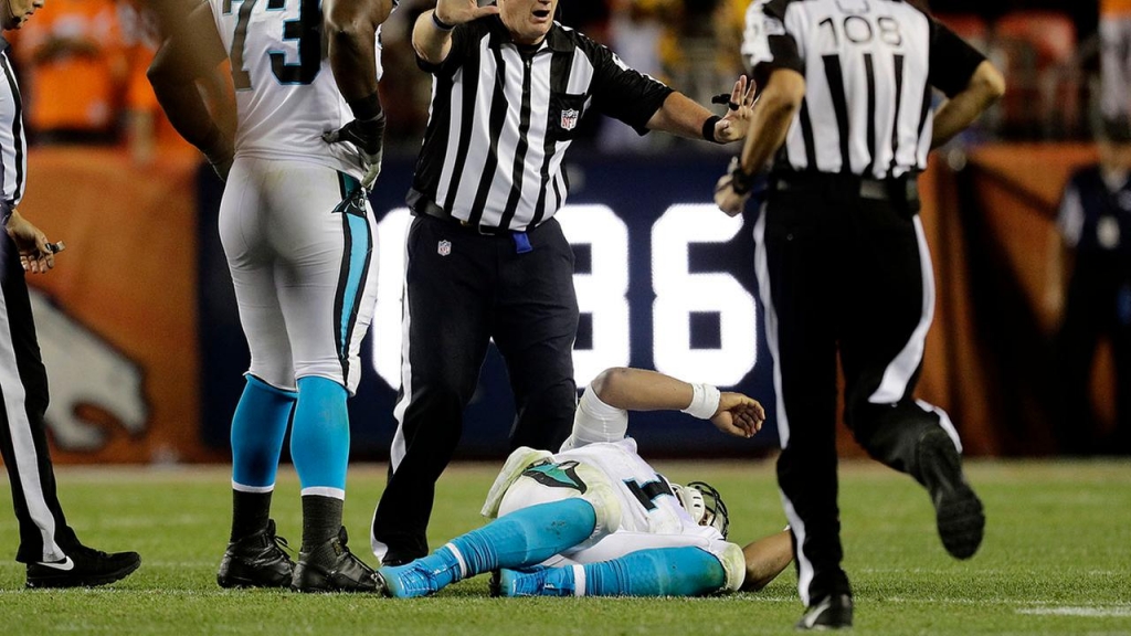 Cam Newton lies on the turf after getting drilled on a helmet-to-helmet hit by Broncos safety Darian Stewart on Thursday in Denver