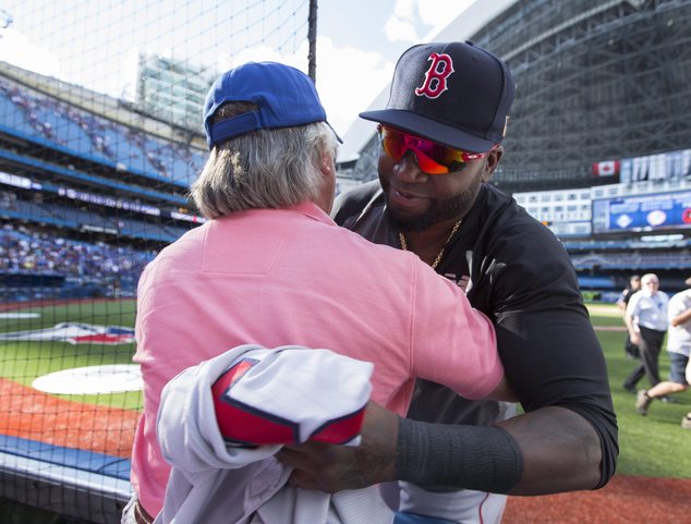 Boston Red Sox designated hitter David Ortiz hugs longtime fan John Teolis before giving him his game jersey following American League MLB baseball acti