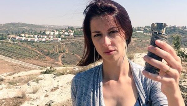 Abby Martin holds up a teargas canister in the Occupied Territories