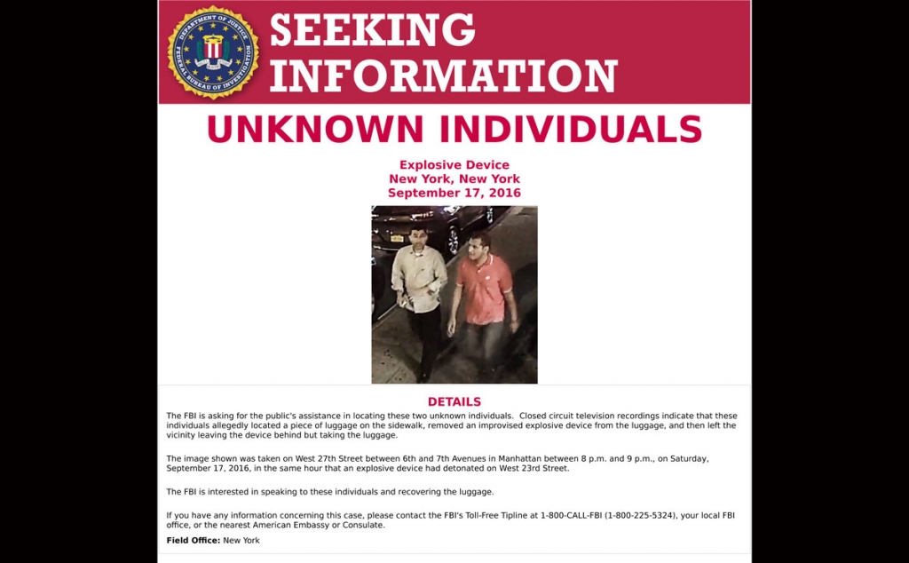 This poster provided by the FBI shows an image of two unidentified men walking on in the Chelsea neighborhood of New York on Saturday Sept. 17 2016 around the time when a bomb exploded on a nearby street