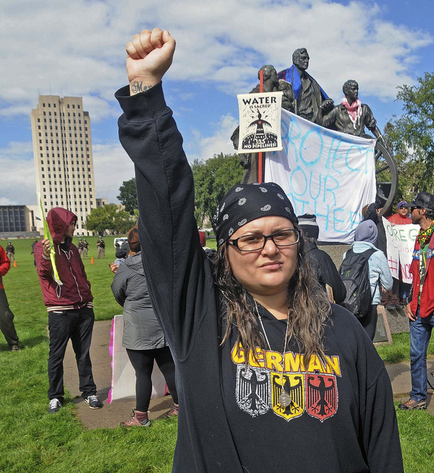 Megan Tobin of Bellevue Ohio protests on the grounds of the North Dakota state capitol Friday Sept. 9 2016 in Bismarck N.D. The federal government stepp