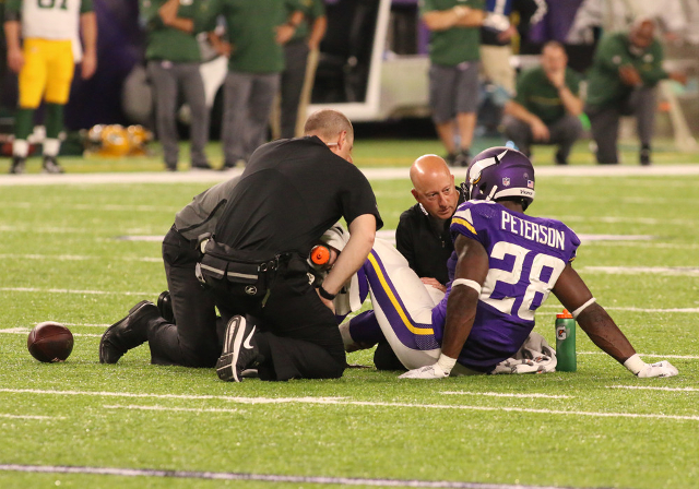 Adrian Peterson is tended to by the Vikings