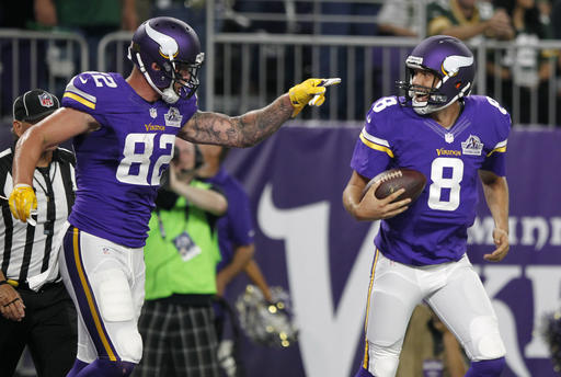 Minnesota Vikings tight end Kyle Rudolph left celebrates with quarterback Sam Bradford after catching an 8-yard touchdown pass during the first half of an NFL football game against the Green Bay Packers Sunday Sept. 18