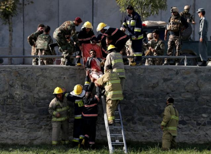 Afghan officials transport a victim after a suicide attack in Kabul Afghanistan