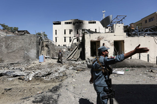 Afghan security forces on Tuesday inspected at the site of suicide attack in Kabul. Click