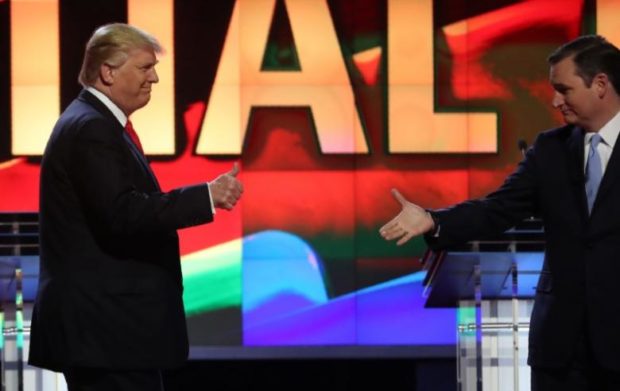 Republican U.S. presidential candidate Donald Trump gives a thumbs up as rival Ted Cruz reaches out to shake his hand before the start of the Republican U.S. presidential candidates debate sponsored by CNN at the University of Miam