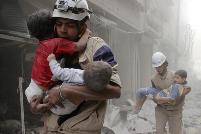 Members of the Civil Defence rescue children after what activists said was an air strike by forces loyal to Syria`s President Assad in al Shaar neighbourhood of Aleppo