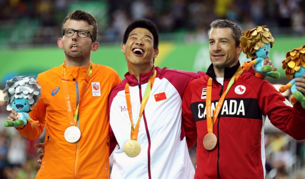 Silver medalist Arnoud Nijhuis of Netherlands gold medalist Zhangyu Li of China and bronze medalist Tristen Chernove of Canada celebrate at the medal ceremony for the men's C