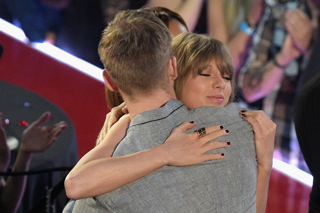 INGLEWOOD CALIFORNIA- APRIL 03 Recording artist Taylor Swift hugs Calvin Harris at the iHeartRadio Music Awards which broadcasted live on TBS TNT AND TRUTV from The Forum