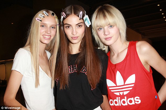 All smiles A trio of models appear excited before the big show as they pose backstage